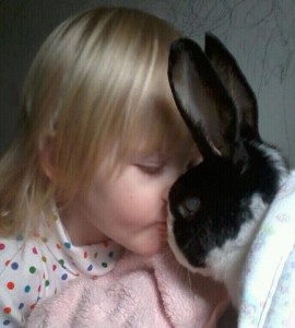 little girl and rabbit snuggling