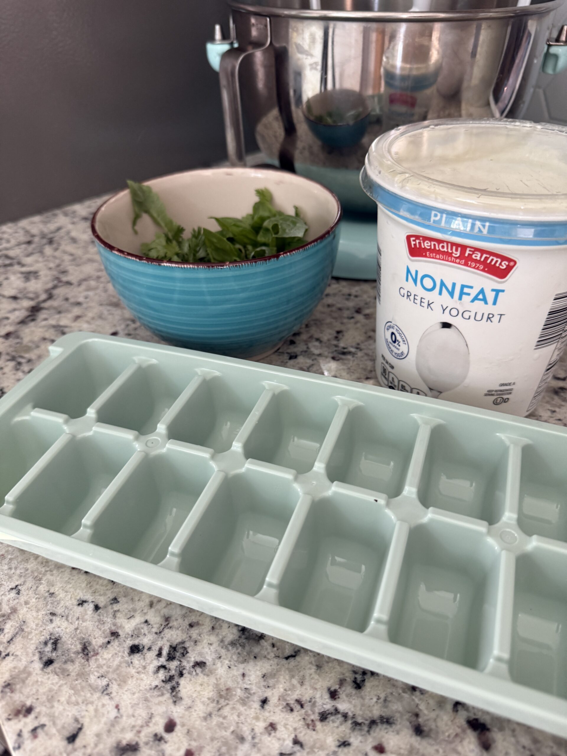 IMG_2144 Ingredients for the yogurt and herb popsicles to help cool my chickens on the counter (plain greek yogurt, herbs, and ice cube trays)